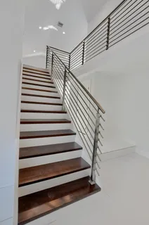a view of a kitchen with refrigerator and windows