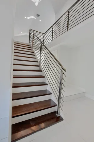 a view of a kitchen with refrigerator and windows