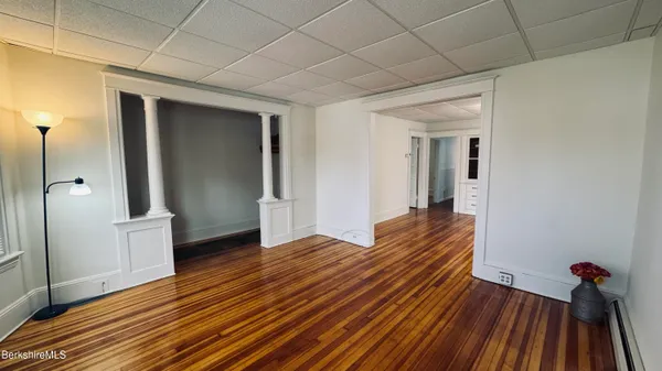 a view of a room with wooden floor and staircase