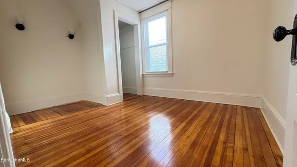 a view of a room with wooden floor and small space
