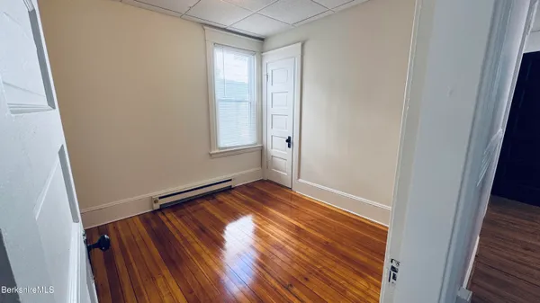 a view of an empty room and wooden floor