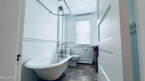 a bathroom with a bathtub and window