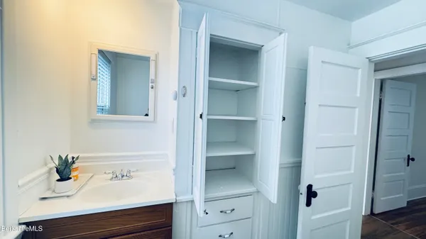a bathroom with a sink and mirror