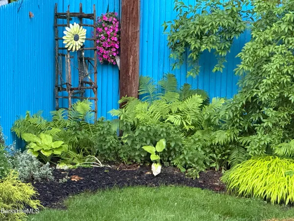 a view of a house with a flower garden