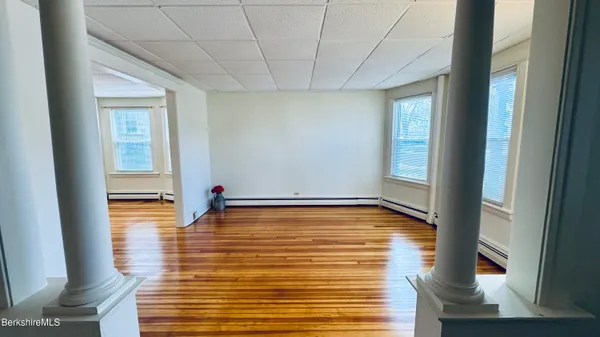 a view of a room with window and wooden floor
