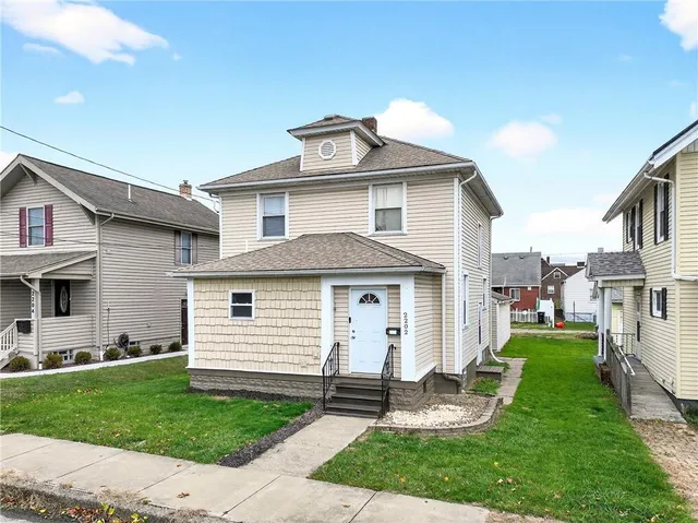 a front view of a house with a yard