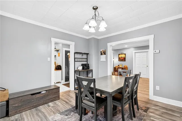 a kitchen with white cabinets and window