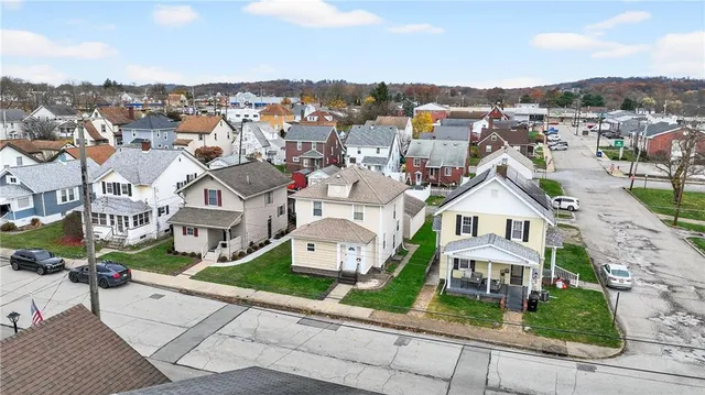 an aerial view of residential houses with city view