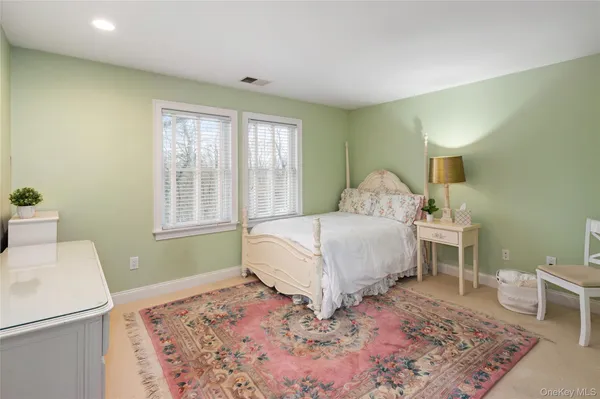 a spacious bedroom with a bed and a window