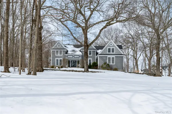 a front view of a house with a yard covered in snow