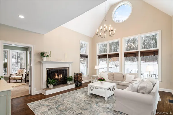 a living room with furniture a window and a fireplace