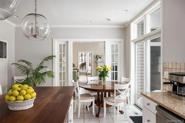 a view of a dining room with furniture and chandelier