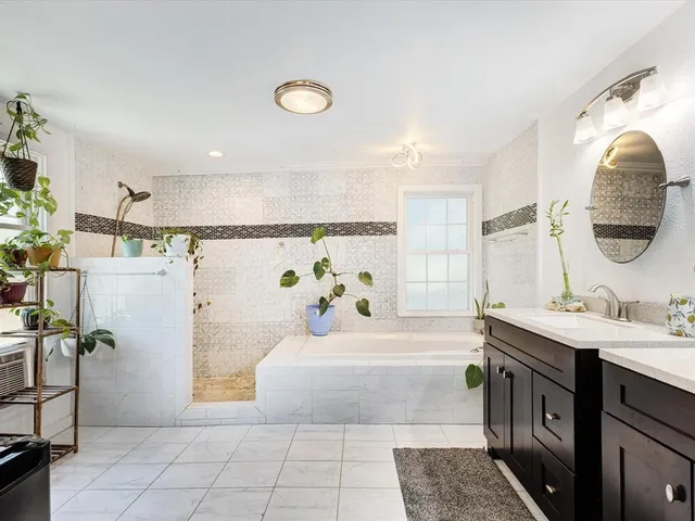 a bathroom with a double vanity sink and a mirror