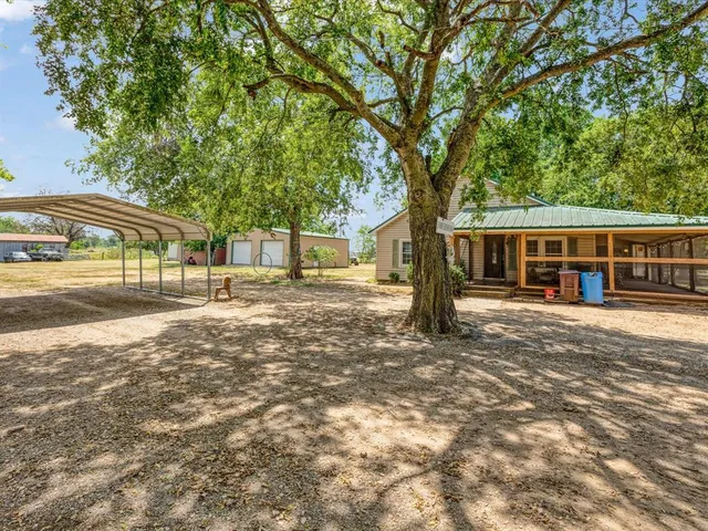 a backyard of a house with barbeque oven
