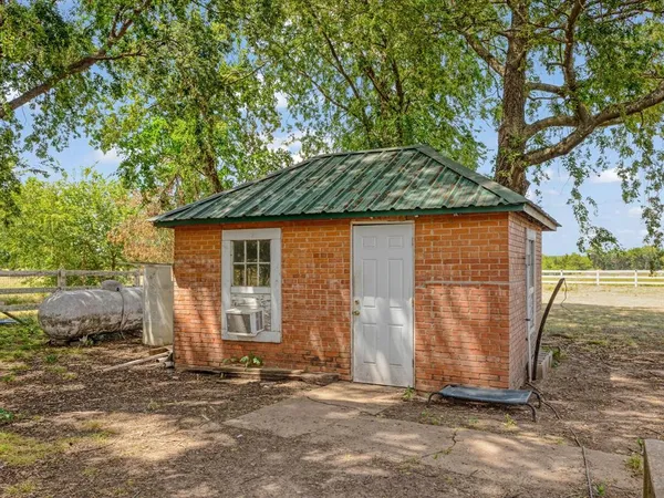 a view of a backyard with a large tree