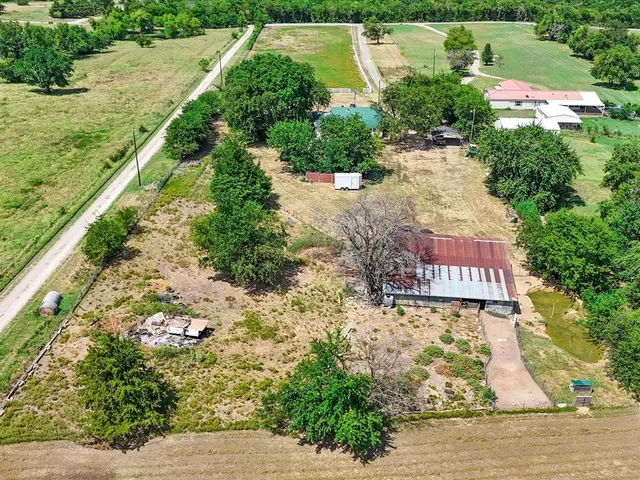 an aerial view of residential house with outdoor space and parking