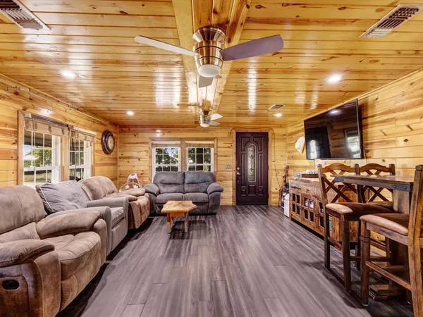 a living room with furniture and wooden floor