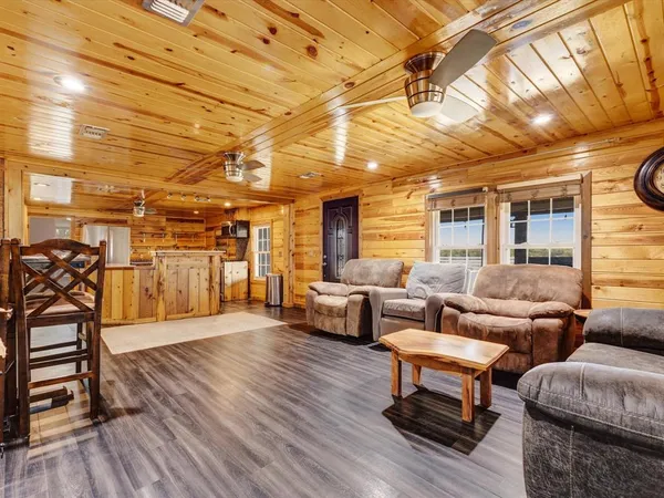 a living room with furniture and wooden floors