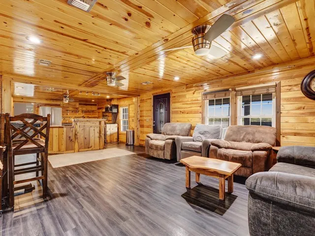 a living room with furniture and wooden floors