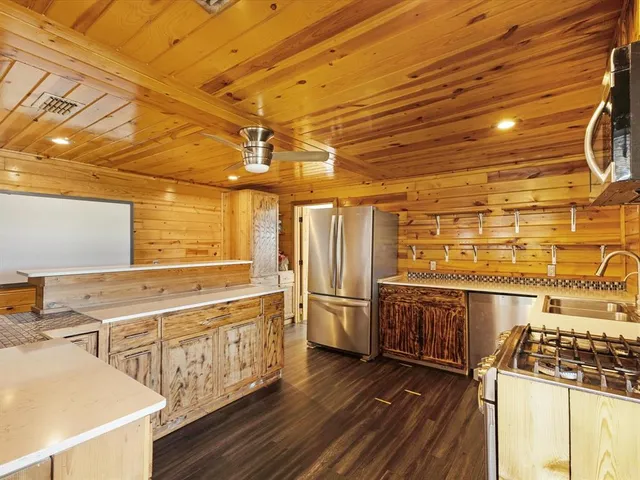 a open kitchen with stainless steel appliances granite countertop a sink and cabinets