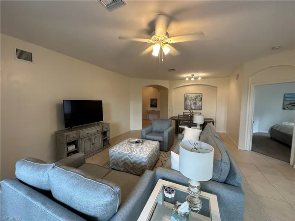 a living room with furniture and a flat screen tv