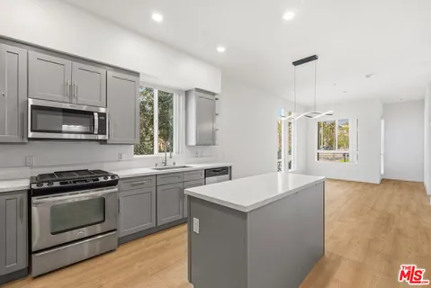 a kitchen with a sink stove and microwave