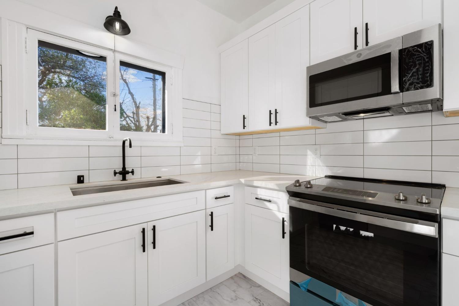 104 King Road Roseville, CA 95678 - Photo 18 of 36 a kitchen with a sink stove and microwave