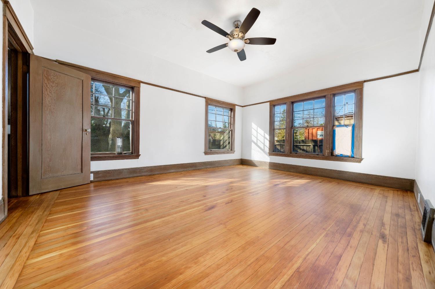 104 King Road Roseville, CA 95678 - Photo 22 of 36 a view of an empty room with a window and wooden floor