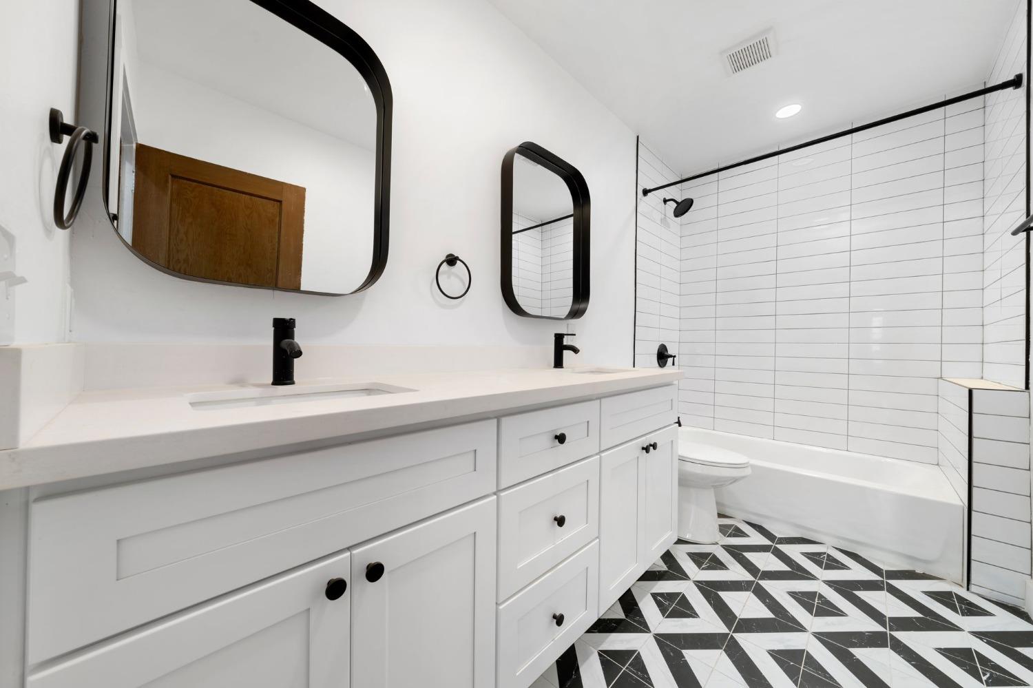 104 King Road Roseville, CA 95678 - Photo 26 of 36 a bathroom with a double vanity sink a mirror and a bathtub