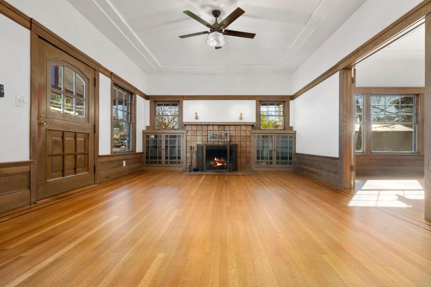 104 King Road Roseville, CA 95678 - Photo 8 of 36 a livingroom with furniture a fireplace a ceiling fan and wooden floor