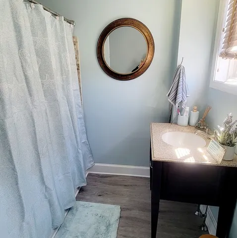 a bathroom with a sink toilet and a mirror