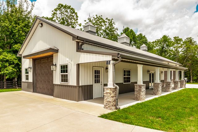 a kitchen with stainless steel appliances granite countertop a kitchen island a stove and a sink