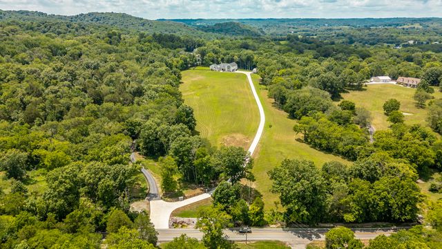 a stove top oven sitting inside of a kitchen and granite counter tops