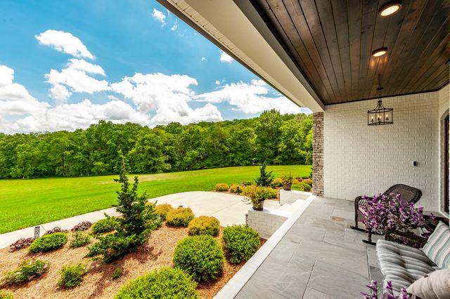 a bedroom with a bed a couch and a window