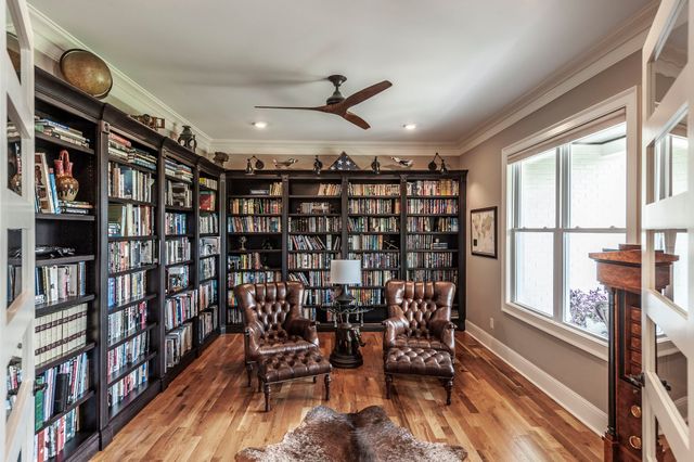 a bathroom with a granite countertop sink a toilet and a mirror