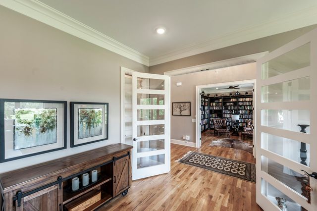 a living room with furniture flat screen tv and wooden floor