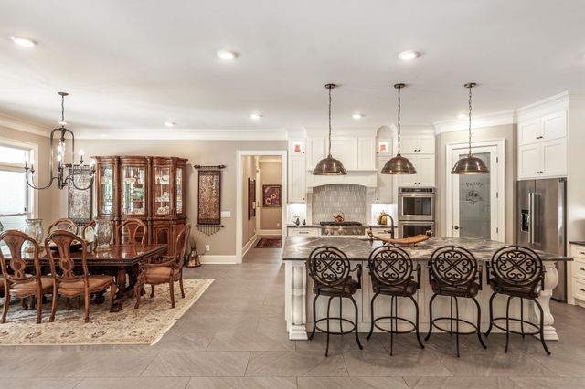 a living room with lots of furniture and wooden floors