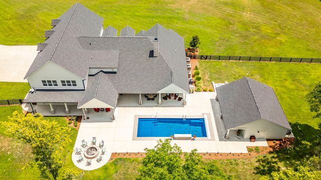 a front view of house with yard and green space