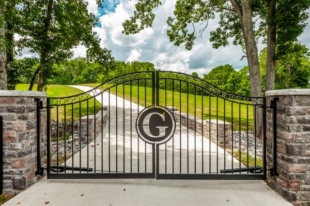 a view of a hallway with wooden floor and windows