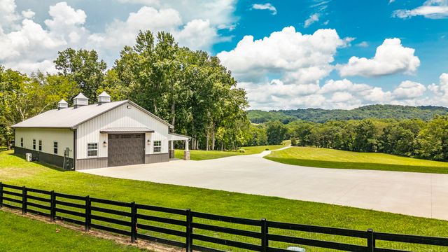a bathroom with a granite countertop toilet sink and mirror