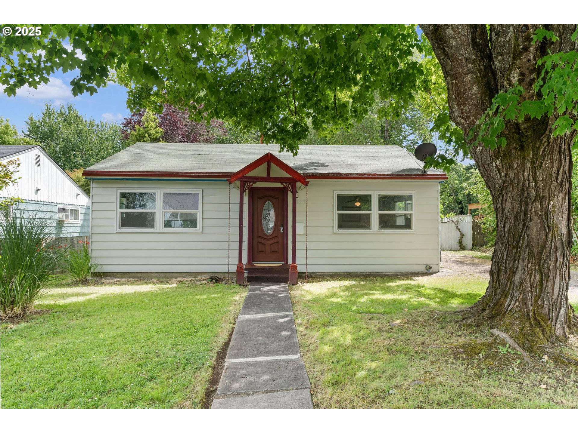 11870 Southwest 13th Street Beaverton, OR 97005 - Photo 3 of 32 a aerial view of a house with yard and tree in the background