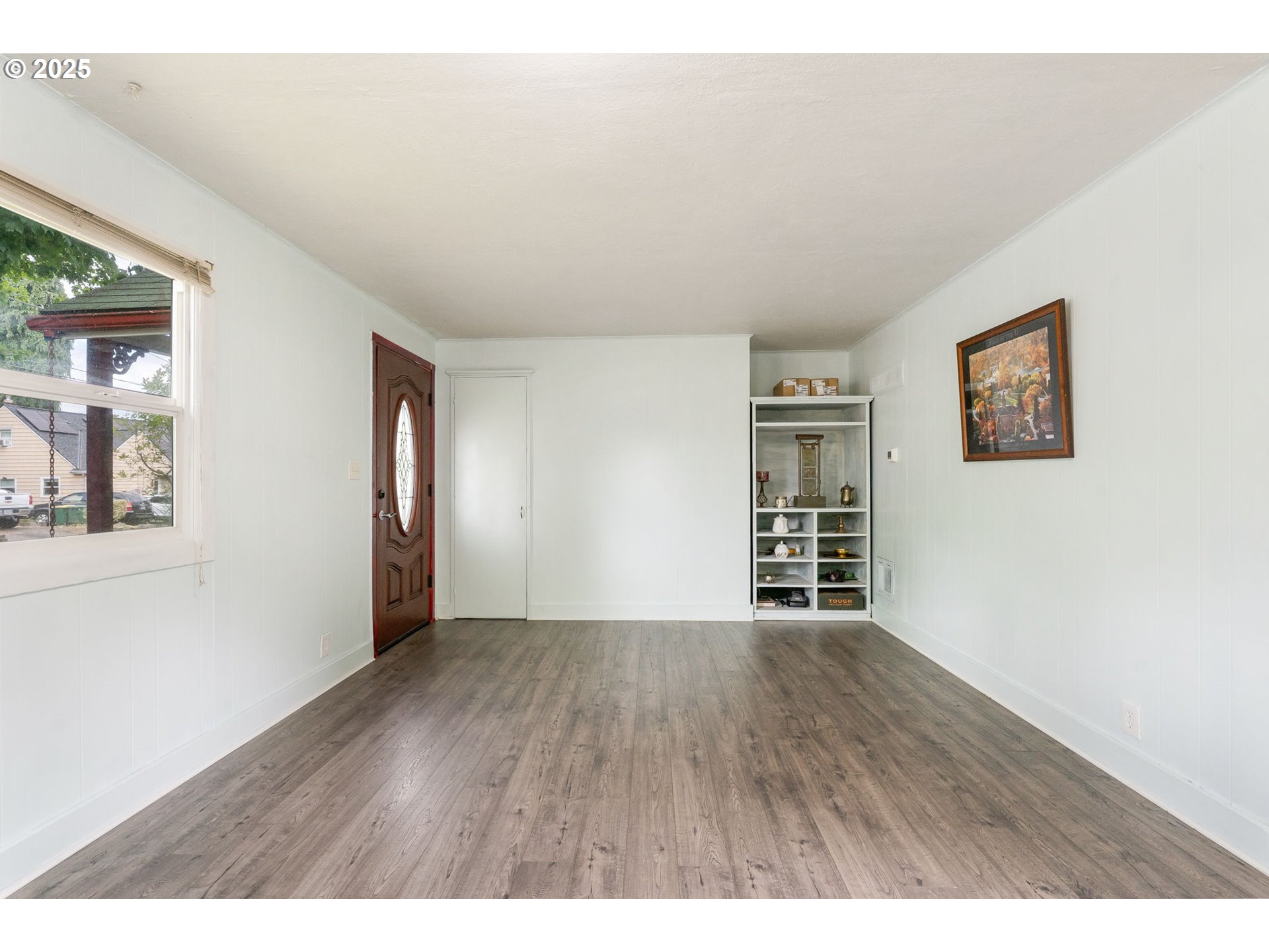 11870 Southwest 13th Street Beaverton, OR 97005 - Photo 5 of 32 a view of an empty room with window and wooden floor