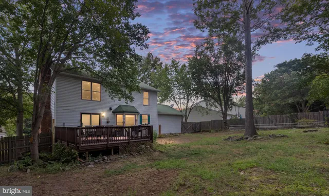 a backyard of a house with barbeque oven and trees