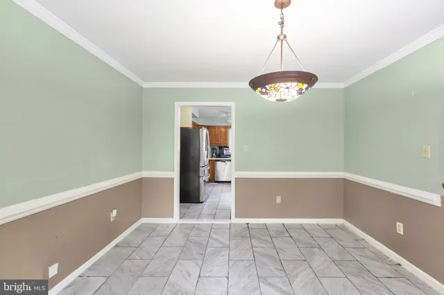 a view of a dining room with furniture wooden floor and chandelier