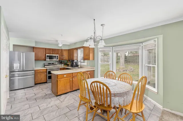 a dining room with furniture a chandelier and fireplace