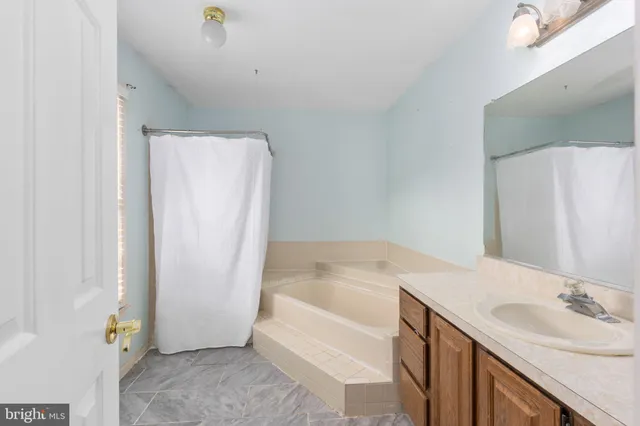 a view of garden with wooden fence