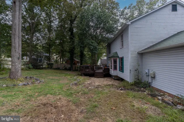 a backyard of a house with barbeque oven table and chairs