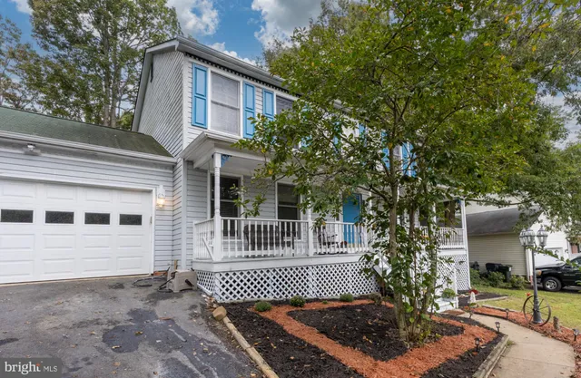 a view of a balcony with chairs and wooden floor
