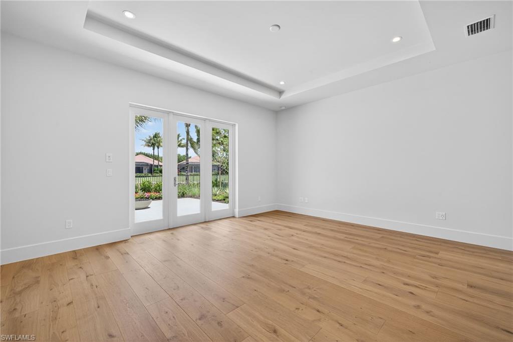 16736 Lucarno Way Naples, FL 34110 - Photo 16 of 49 Master bedroom features french doors leading to private terrace with gas fire pit