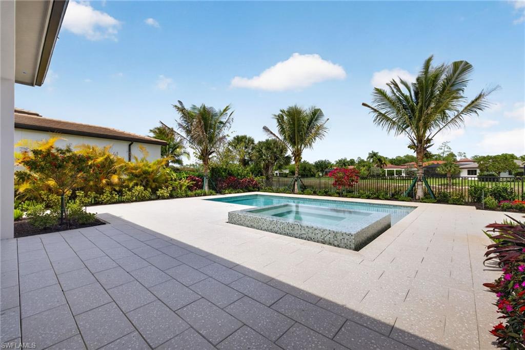 16736 Lucarno Way Naples, FL 34110 - Photo 31 of 49 Pool deck area is spacious for lounging in or out of sun